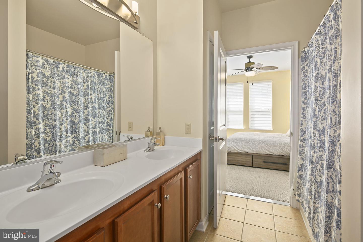 2655 Prosperity Avenue, Unit 108 Fairfax, VA 22031 - Photo 23 of 47 a bathroom with a double vanity sink and a mirror