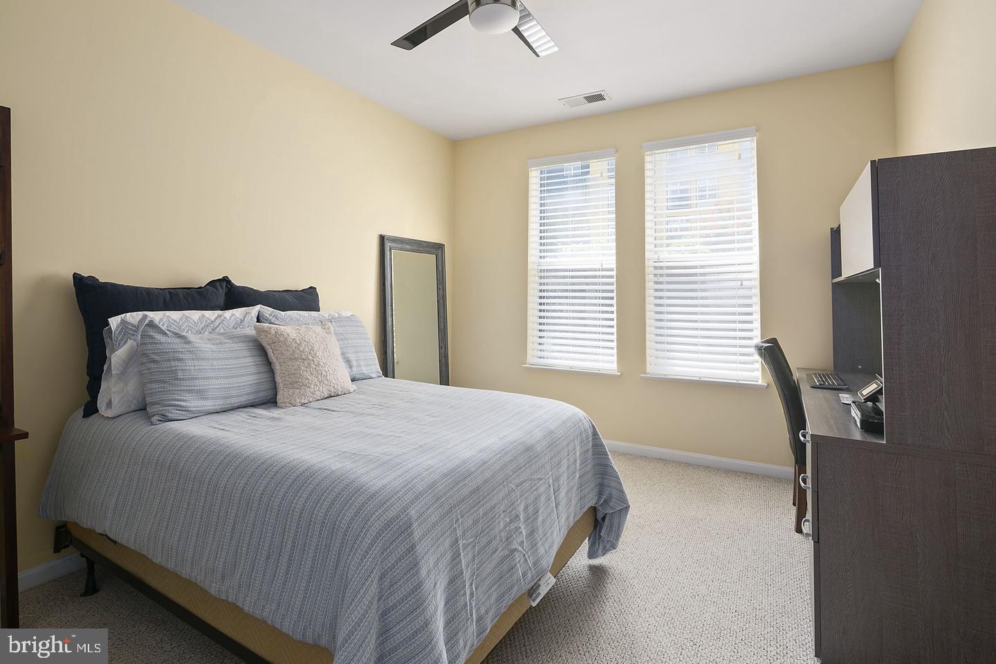2655 Prosperity Avenue, Unit 108 Fairfax, VA 22031 - Photo 25 of 47 a bedroom with a bed tv and a window