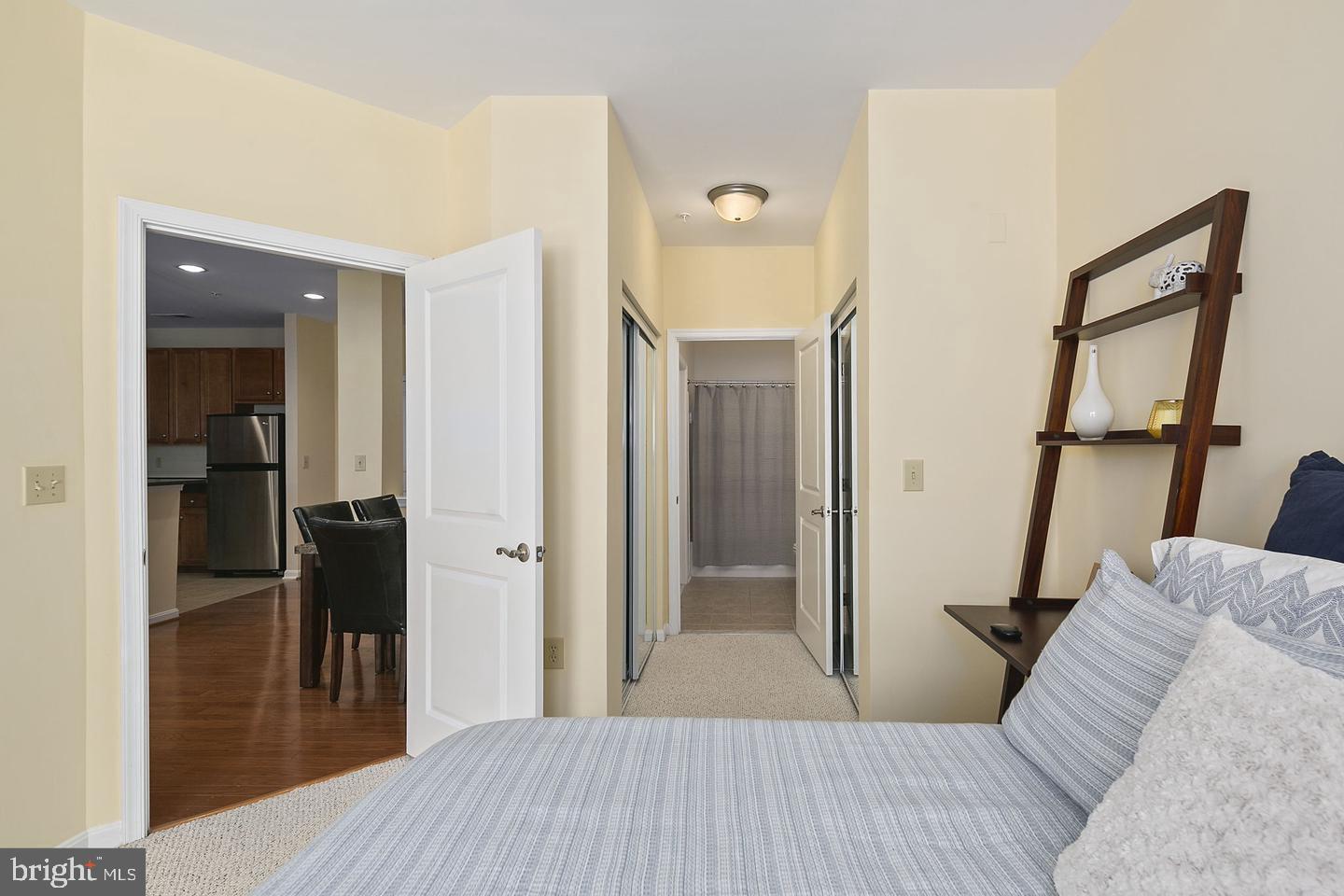 2655 Prosperity Avenue, Unit 108 Fairfax, VA 22031 - Photo 26 of 47 a bedroom with a bed and a mirror
