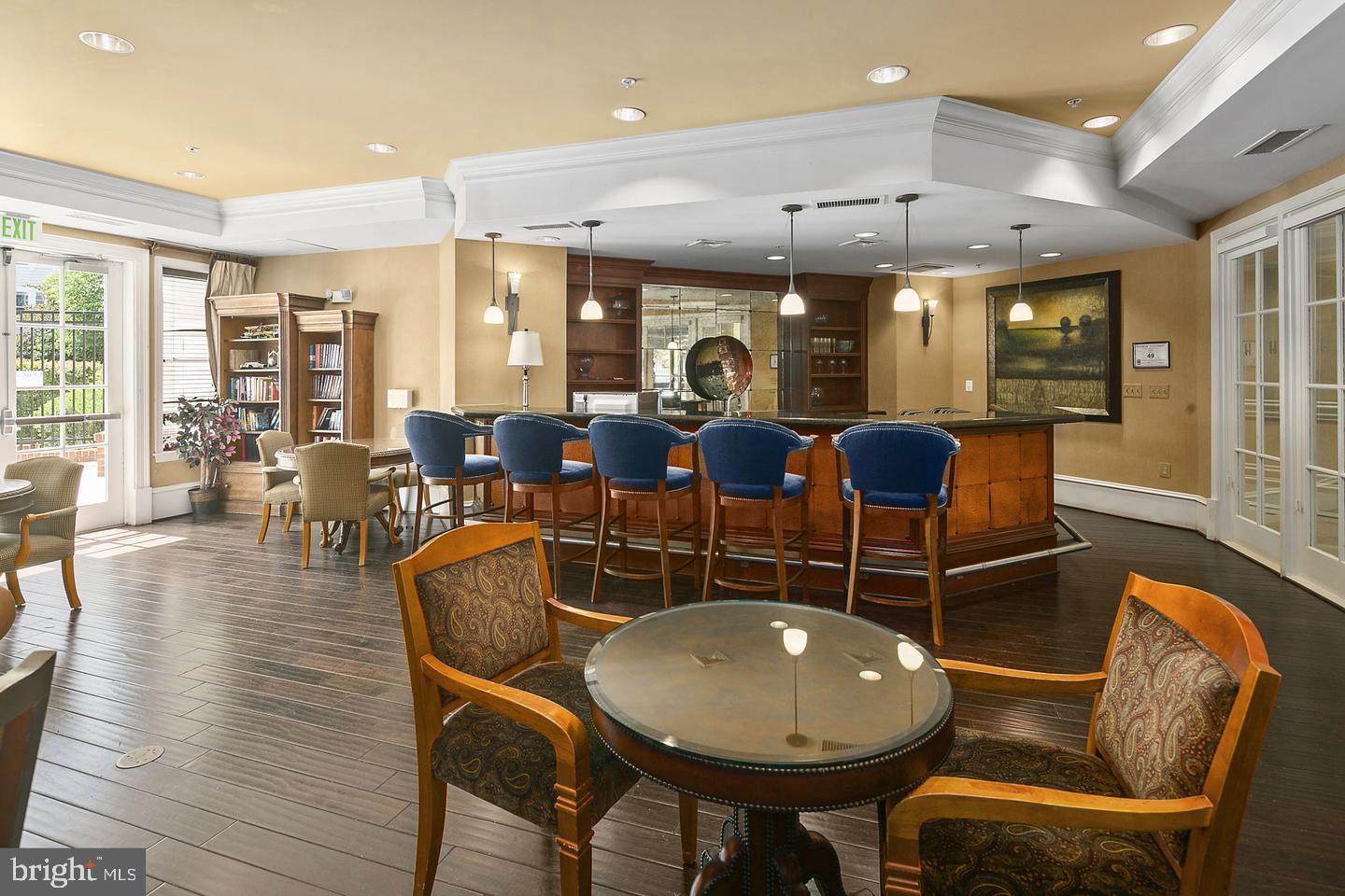 2655 Prosperity Avenue, Unit 108 Fairfax, VA 22031 - Photo 29 of 47 a dining room with wooden floor a glass table and chairs