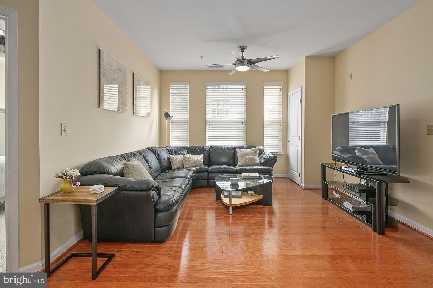 2655 Prosperity Avenue, Unit 108 Fairfax, VA 22031 - Photo 4 of 47 a living room with furniture and a flat screen tv