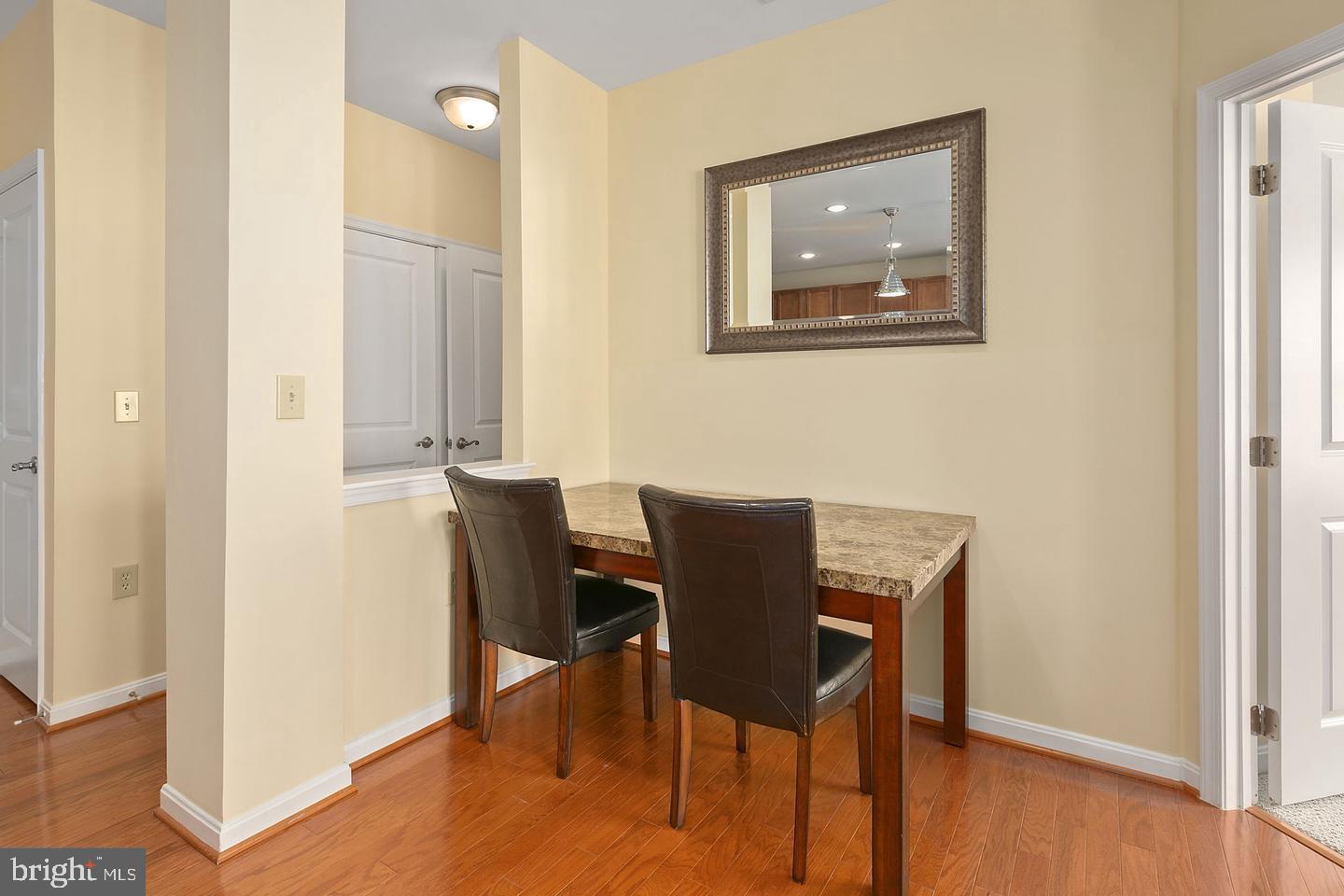 2655 Prosperity Avenue, Unit 108 Fairfax, VA 22031 - Photo 8 of 47 a view of a dining room with furniture and wooden floor