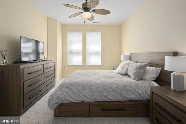 a bedroom with a bed and flat screen tv