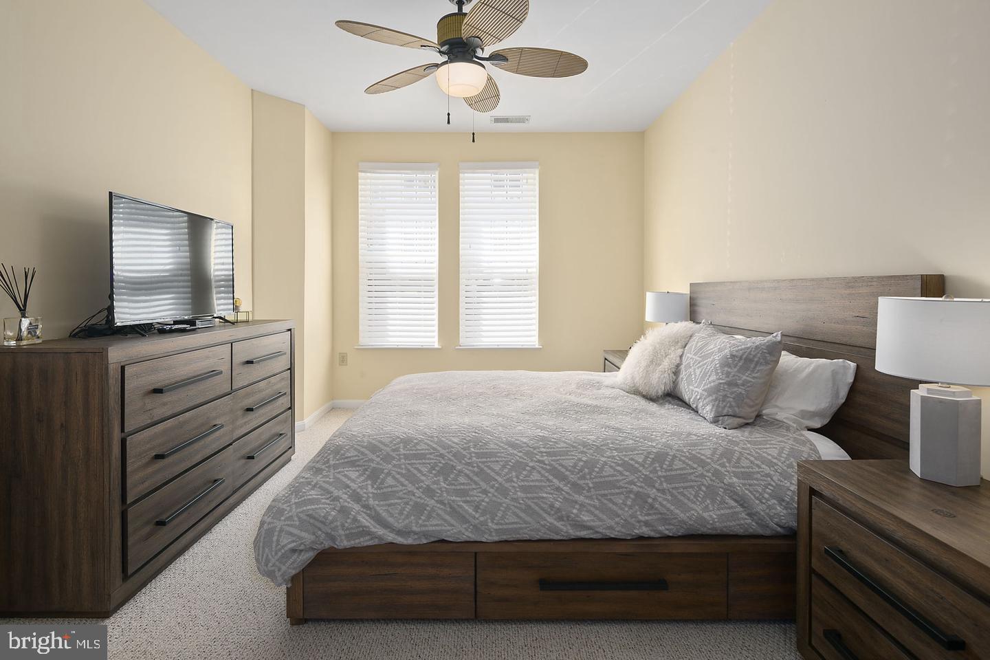 2655 Prosperity Avenue, Unit 108 Fairfax, VA 22031 - Photo 9 of 47 a bedroom with a bed and flat screen tv