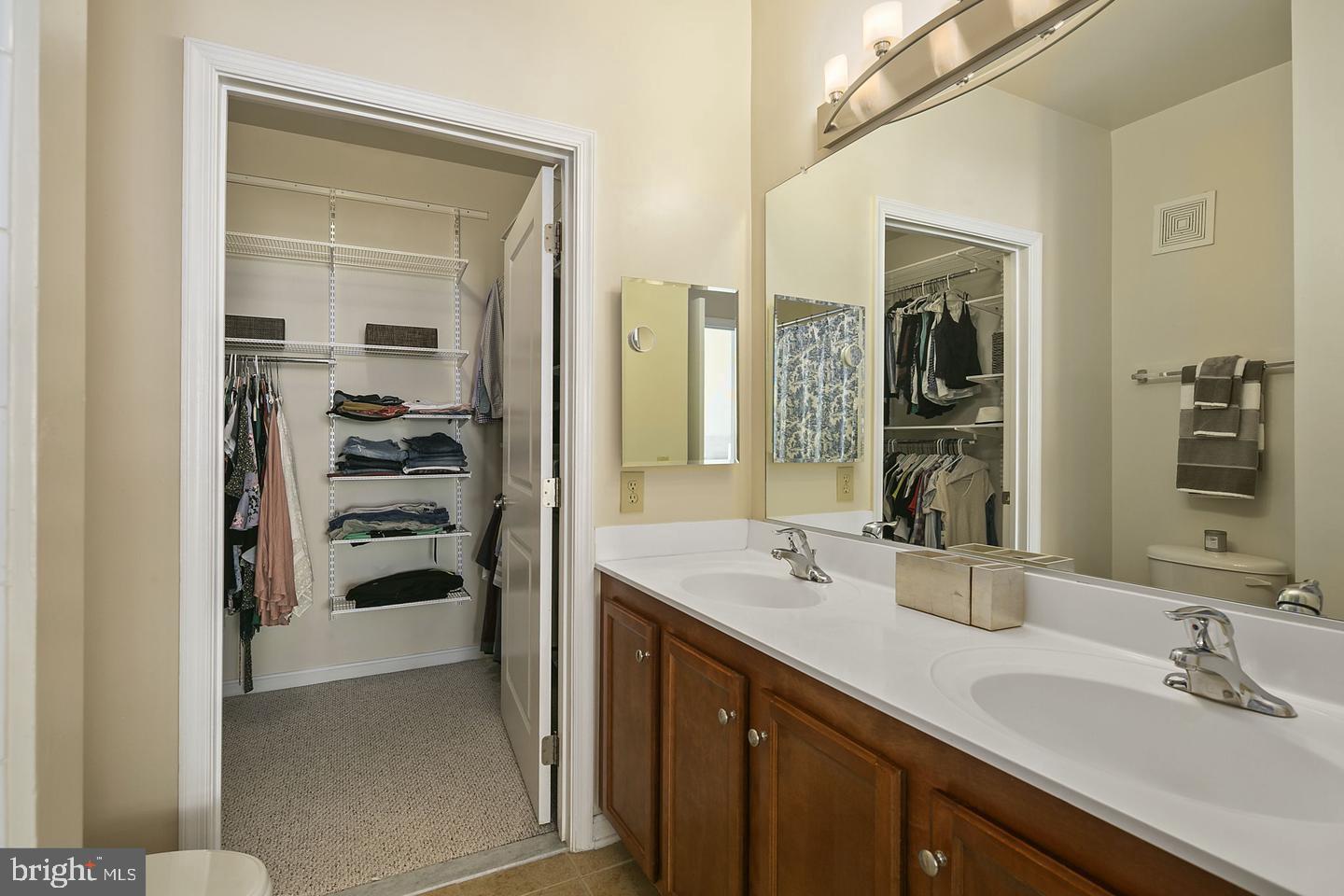 2655 Prosperity Avenue, Unit 108 Fairfax, VA 22031 - Photo 10 of 47 a bathroom with a double vanity sink a and mirror