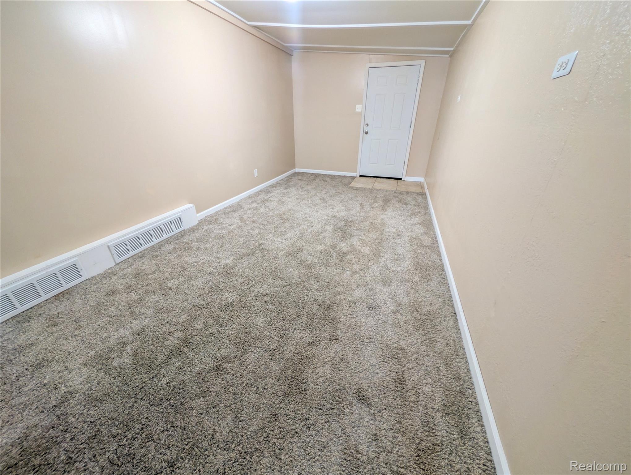 15870 Allen Road Taylor, MI 48180 - Photo 9 of 14 Neutral-toned wall paint, light-colored carpeting, white trim, and a white paneled door