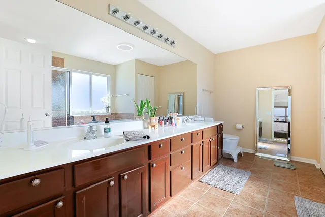 a spacious bathroom with a double vanity sink and a mirror