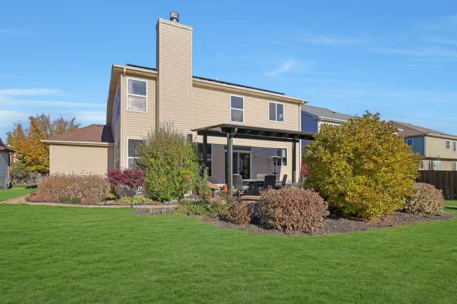 a front view of a house with a garden and plants