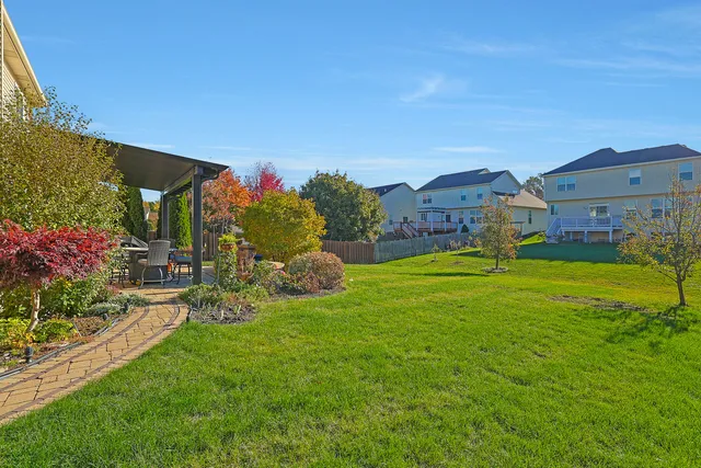 a view of a house with a big yard and potted plants