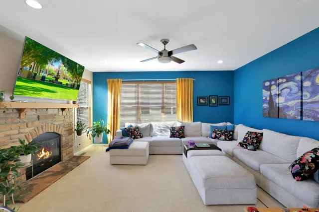 a living room with furniture and a fireplace