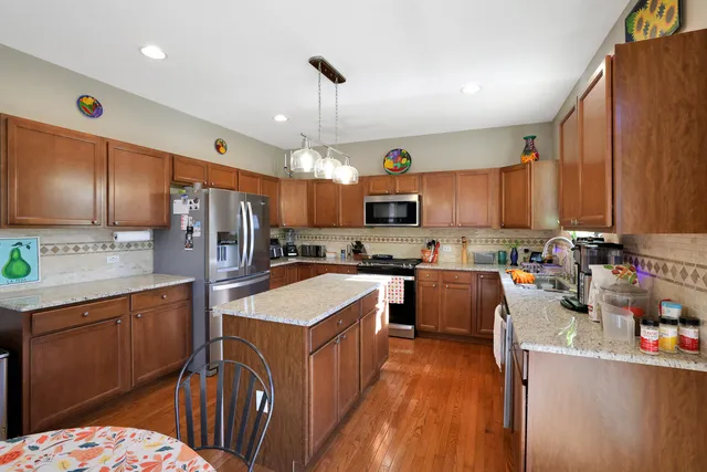 a kitchen with refrigerator a sink and wooden cabinets