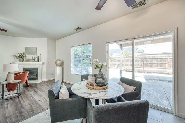 a dining room with furniture a large window and a chandelier