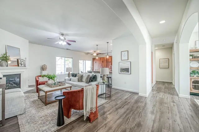 a living room with furniture and wooden floor
