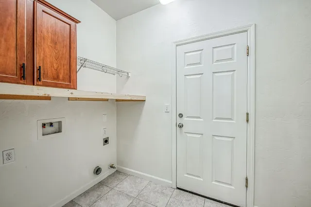 a view of storage and utility room with closet