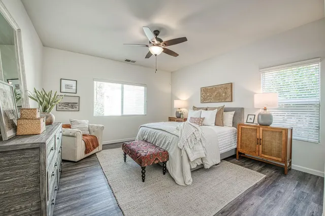 a spacious bedroom with a bed and a couch