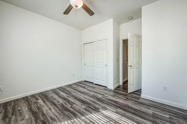 a view of a room with wooden floor