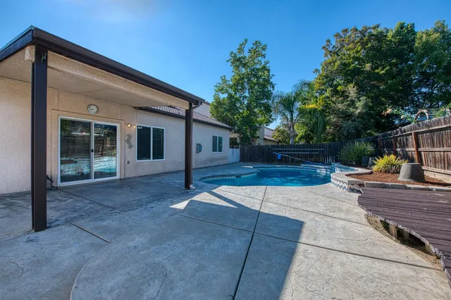 a view of a house with backyard and sitting area