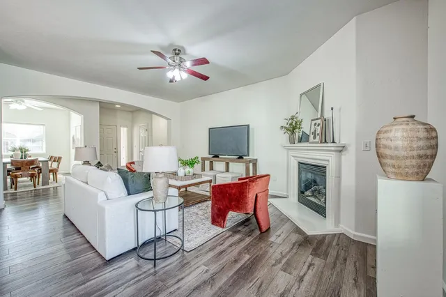 a living room with furniture a fireplace and a flat screen tv