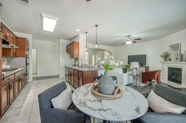 a living room with furniture a fireplace and a flat screen tv