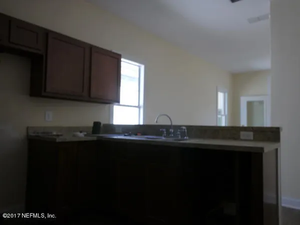 a kitchen with granite countertop a sink stainless steel appliances and cabinets