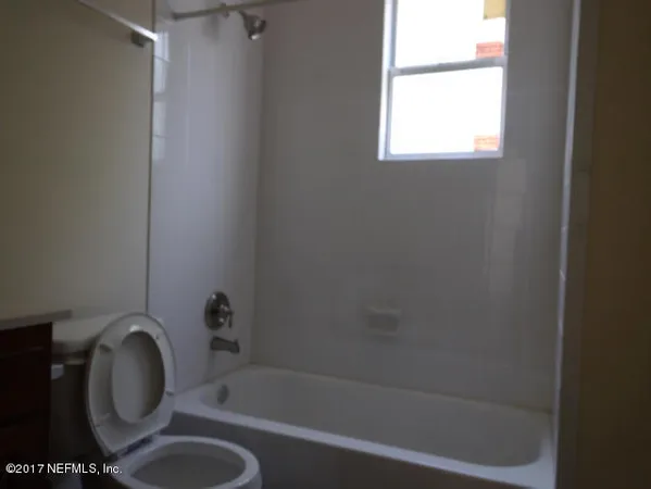 a bath room with a sink toilet and shower