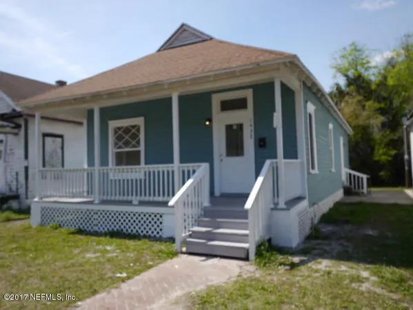 a view of a house with wooden floor and a yard