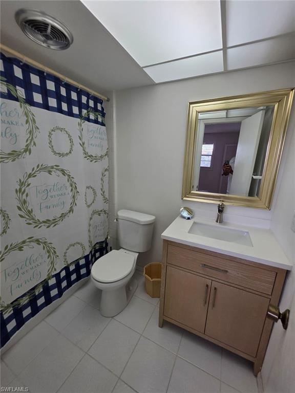 160 Turtle Lake Court, Unit 209 Naples, FL 34105 - Photo 12 of 26 a bathroom with a toilet sink and mirror