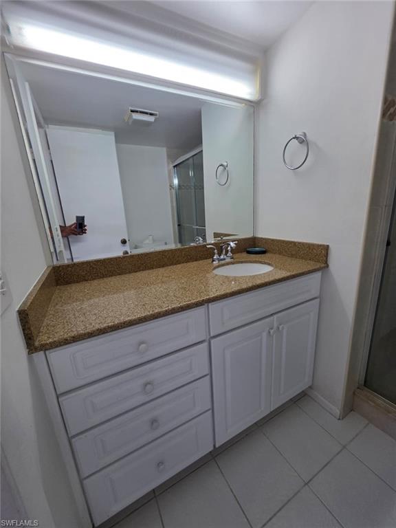 160 Turtle Lake Court, Unit 209 Naples, FL 34105 - Photo 14 of 26 a bathroom with a granite countertop sink and a mirror