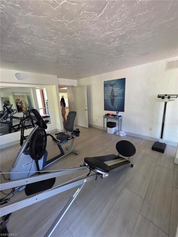 160 Turtle Lake Court, Unit 209 Naples, FL 34105 - Photo 20 of 26 a view of a room with gym equipment