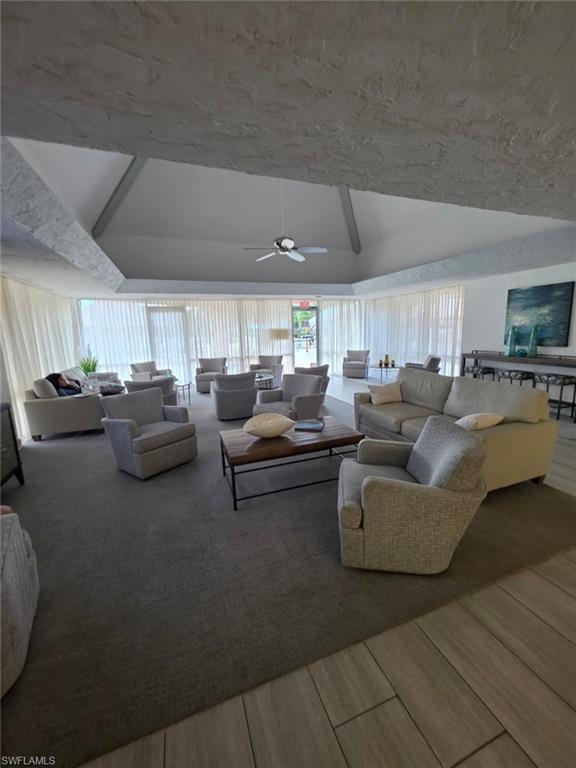 160 Turtle Lake Court, Unit 209 Naples, FL 34105 - Photo 22 of 26 a living room with furniture and a flat screen tv