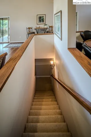 a view of a house with a yard and large trees