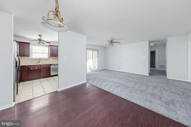 a view of a kitchen with a sink and dishwasher wooden floor