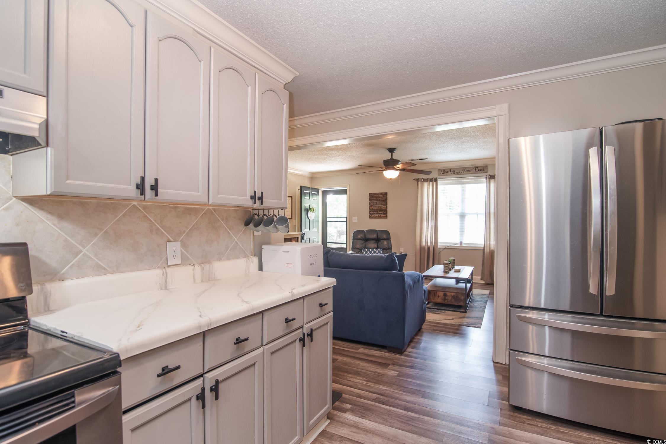 2510 Redwood Street Georgetown, SC 29440 - Photo 11 of 27 Kitchen featuring electric stove, a sink, gray cabinets, tasteful backsplash, and under cabinet range hood