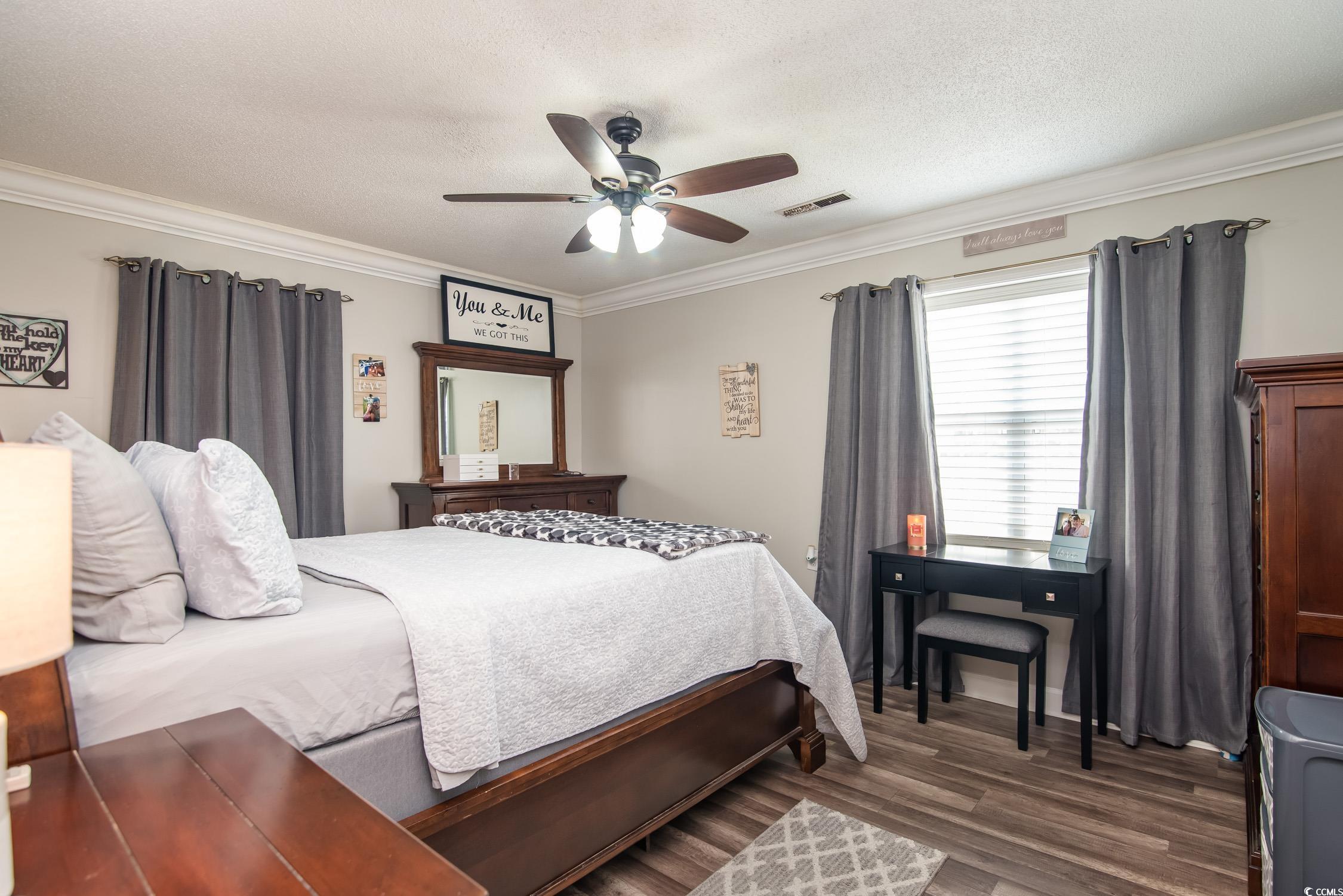 2510 Redwood Street Georgetown, SC 29440 - Photo 12 of 27 Kitchen with appliances with stainless steel finishes, ornamental molding, dark wood-style flooring, decorative backsplash, and a textured ceiling