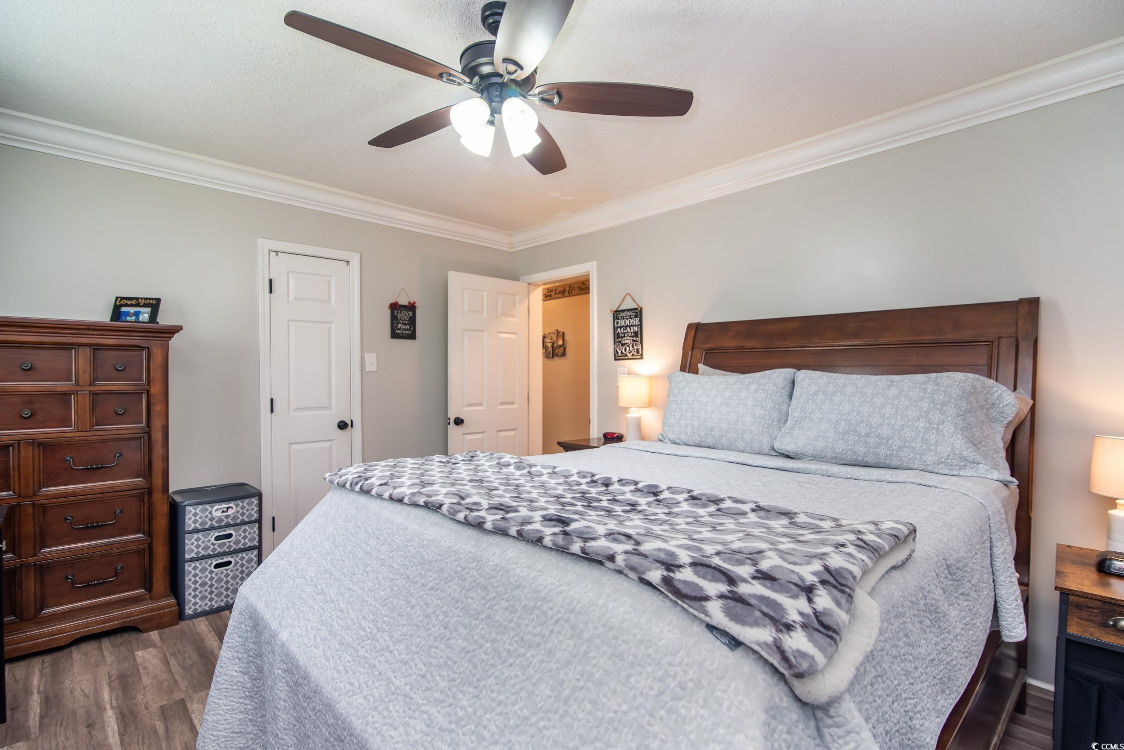 2510 Redwood Street Georgetown, SC 29440 - Photo 13 of 27 Bedroom featuring ornamental molding, wood finished floors, ceiling fan, and a textured ceiling