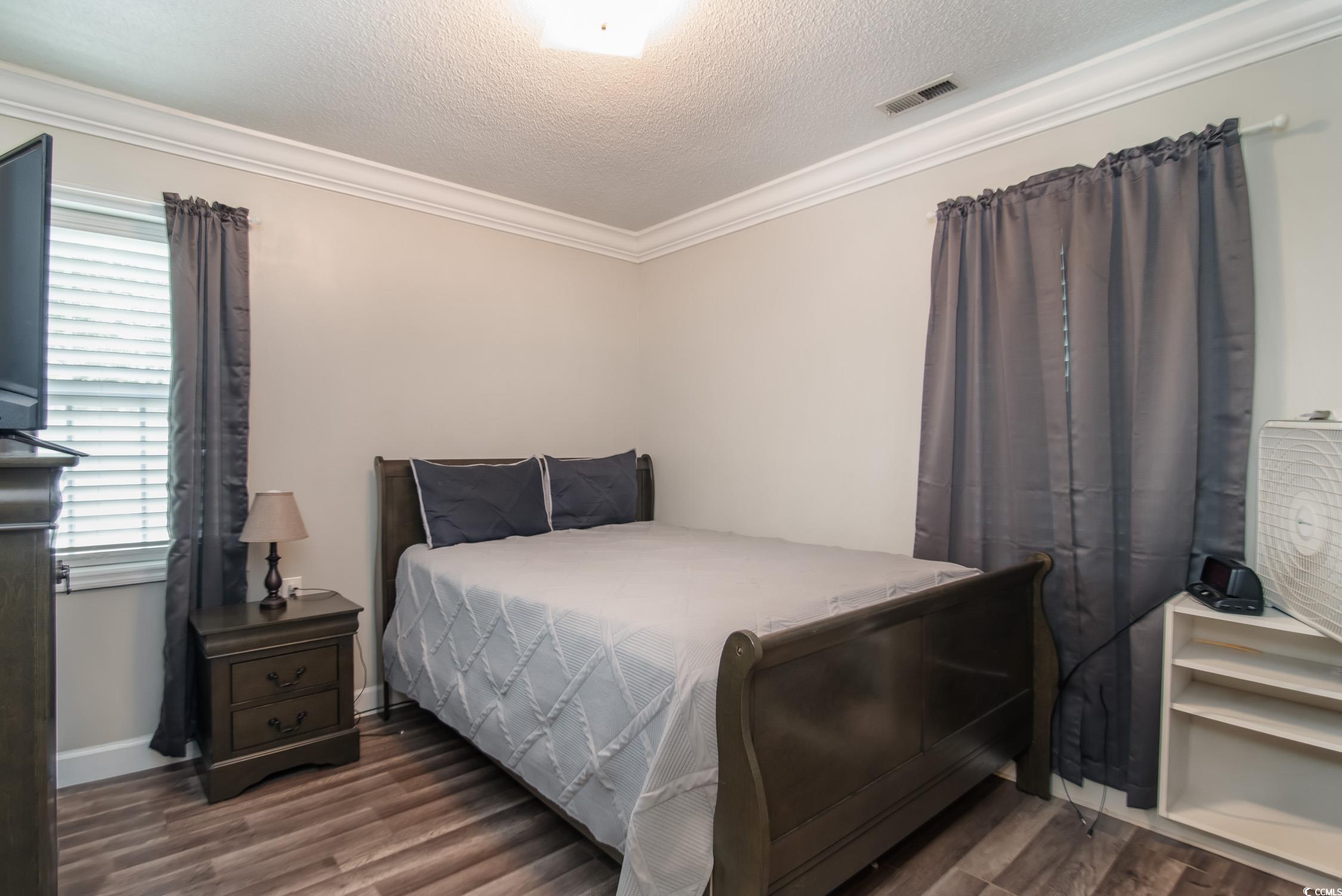 2510 Redwood Street Georgetown, SC 29440 - Photo 16 of 27 Full bath with ornamental molding, vanity, toilet, wood finished floors, and a shower with curtain
