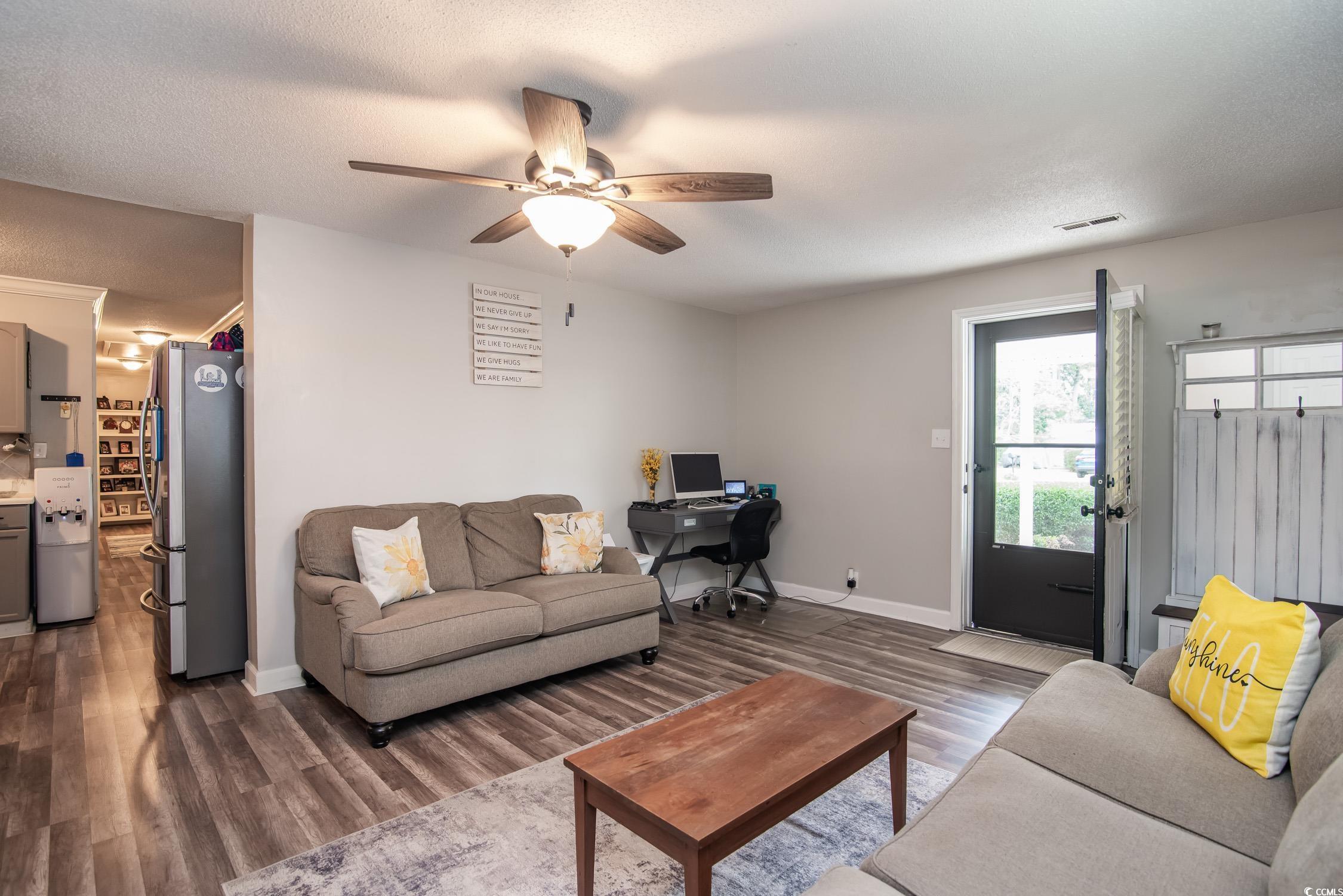 2510 Redwood Street Georgetown, SC 29440 - Photo 17 of 27 Bedroom with wood finished floors, crown molding, and a textured ceiling