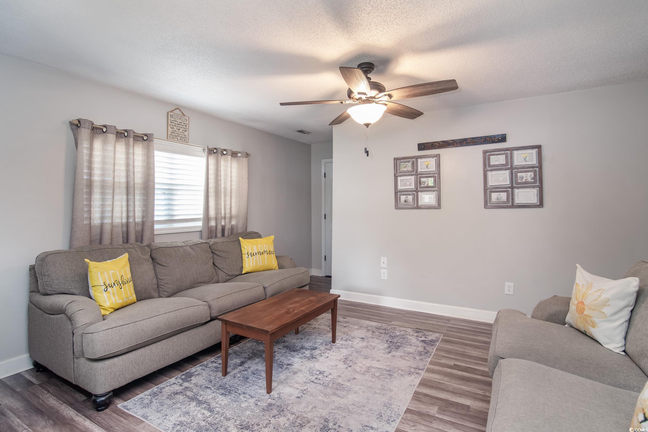 2510 Redwood Street Georgetown, SC 29440 - Photo 18 of 27 Living room featuring a desk, dark wood-style flooring, a ceiling fan, and baseboards