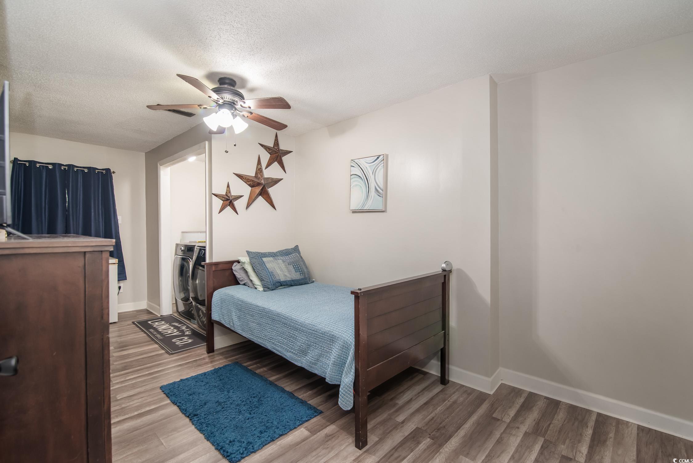 2510 Redwood Street Georgetown, SC 29440 - Photo 19 of 27 Living area featuring a ceiling fan, wood finished floors, baseboards, and a textured ceiling