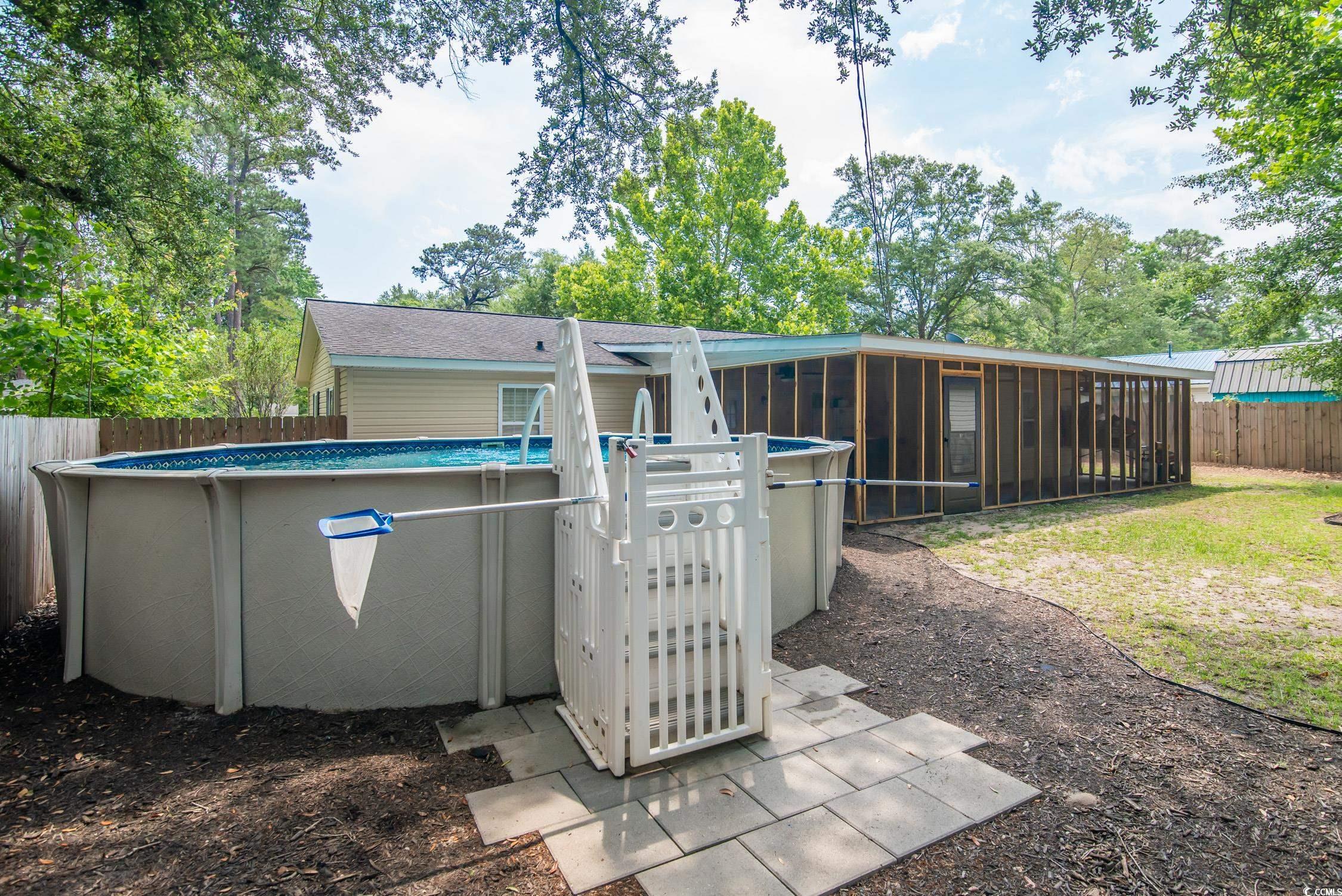 2510 Redwood Street Georgetown, SC 29440 - Photo 26 of 27 View of yard with a sunroom and an outdoor pool