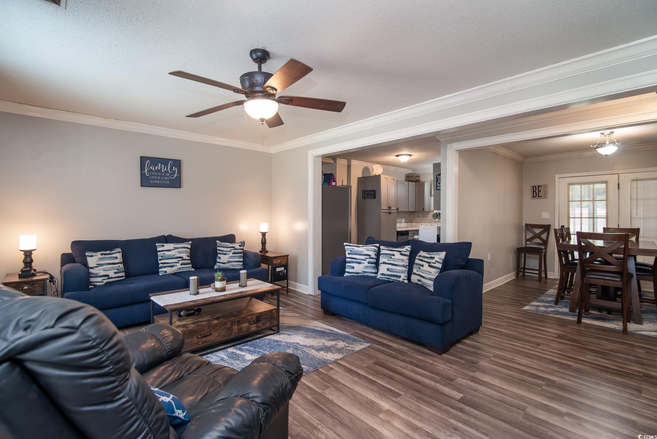 2510 Redwood Street Georgetown, SC 29440 - Photo 5 of 27 Living room featuring a ceiling fan, baseboards, ornamental molding, and wood finished floors