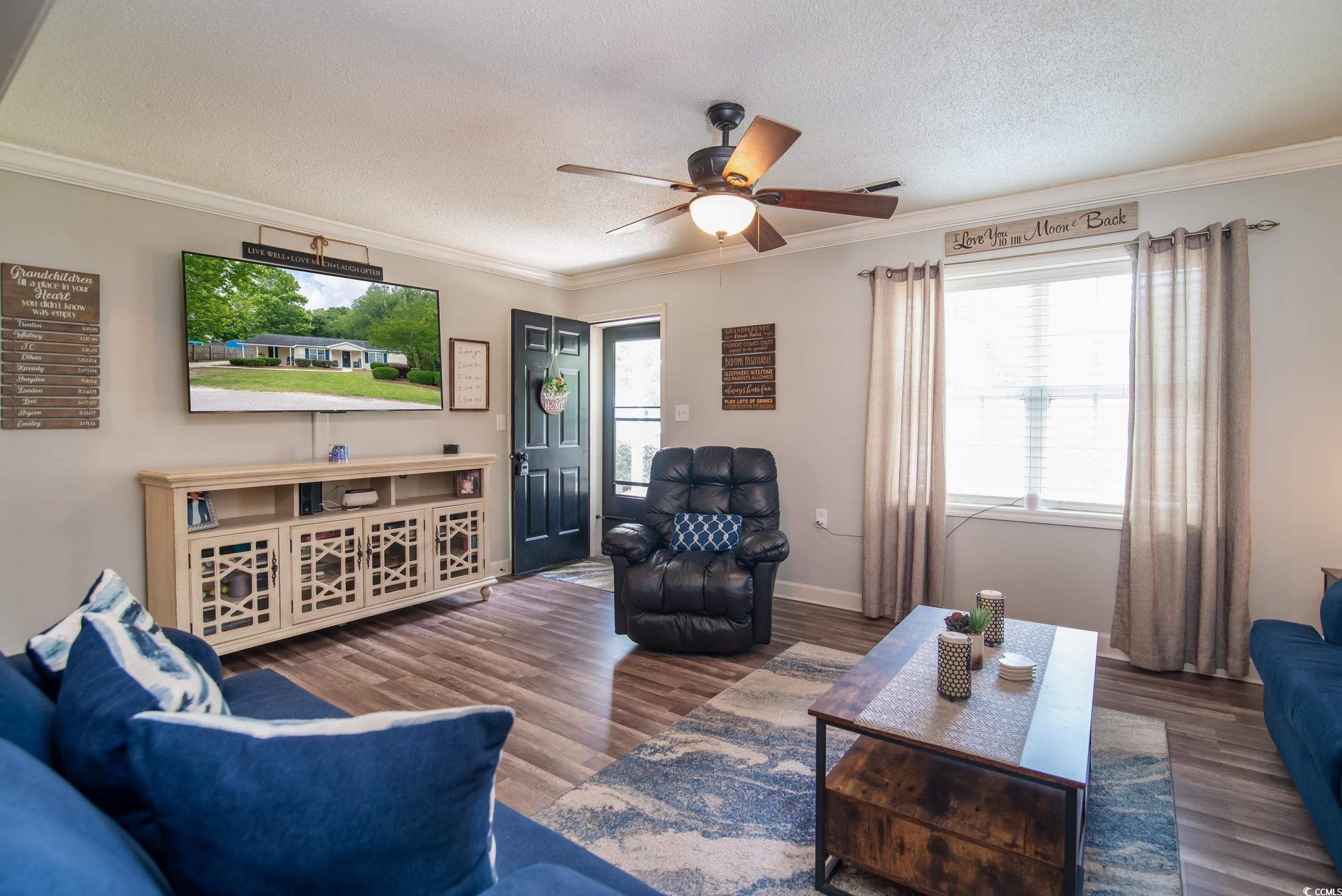 2510 Redwood Street Georgetown, SC 29440 - Photo 7 of 27 Living room with crown molding, wood finished floors, a ceiling fan, a textured ceiling, and baseboards