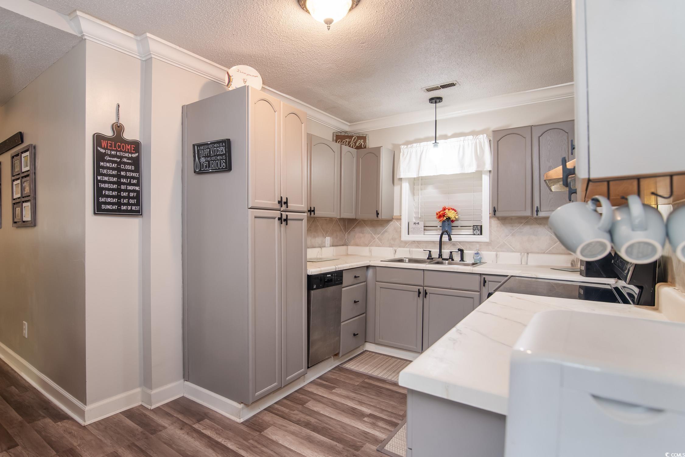 2510 Redwood Street Georgetown, SC 29440 - Photo 9 of 27 Dining area featuring wood finished floors, ornamental molding, baseboards, and a textured ceiling