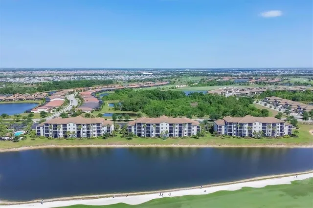 an aerial view of residential houses with outdoor space and river