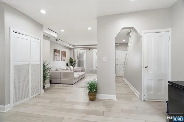 a living room with furniture and a potted plant