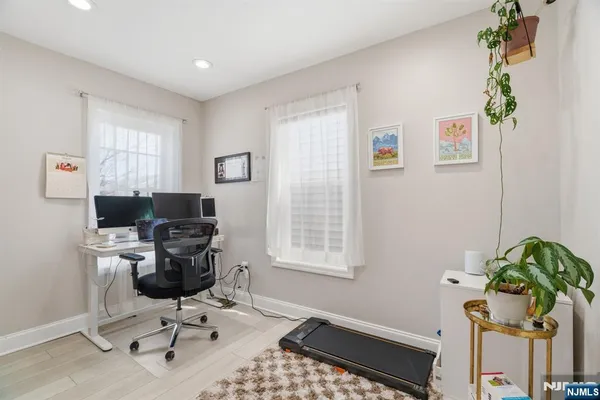 a view of a workspace with furniture and a window