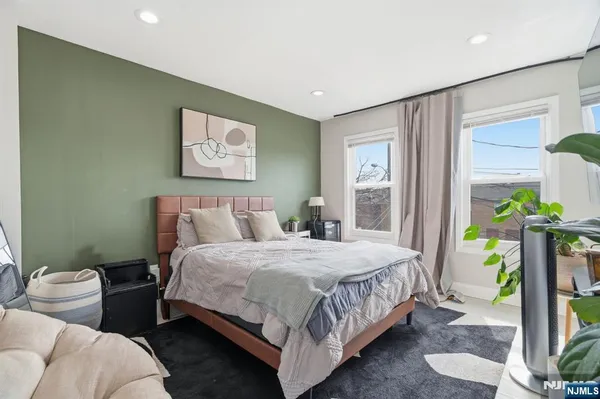 a bedroom with a bed potted plant and a window