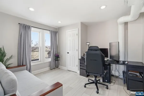 a livingroom with workspace and a window