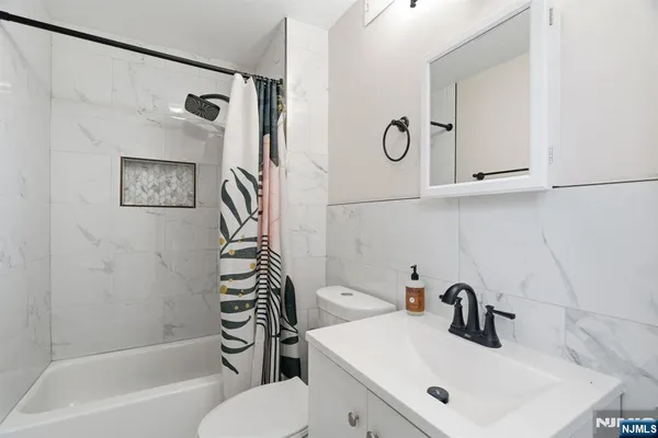 a bathroom with a sink a toilet and a bathtub