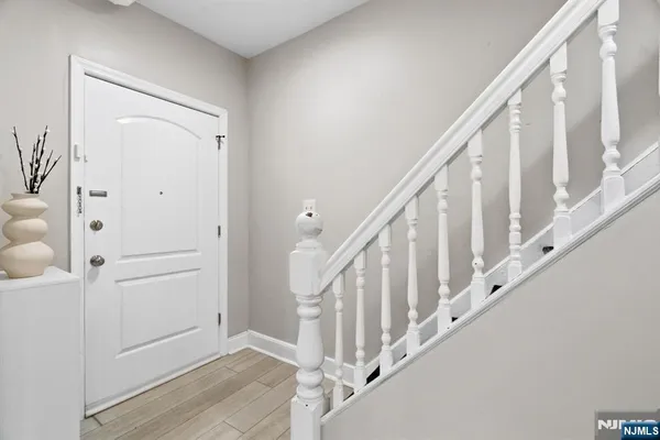 a view of an entryway with wooden floor